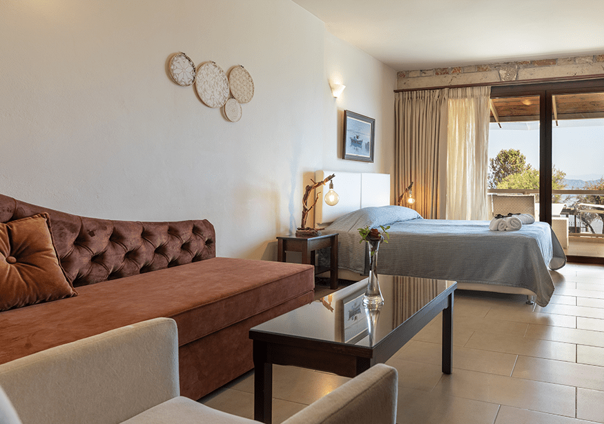 Suites interior with sofa, bed and balcony view